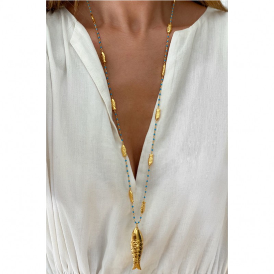 Stylish woman wearing Gioia Fish Necklace by Sara Lashay