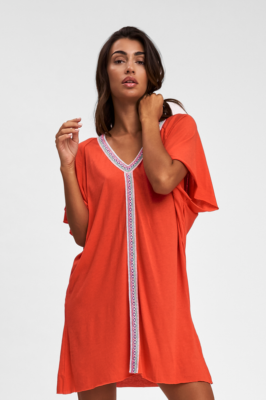 Woman wearing the Mini Pima Abaya Blood Orange beach shirt cover up