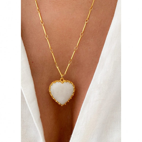 Close-up of Hand-Carved Heart Pendant on Gold Chain Necklace