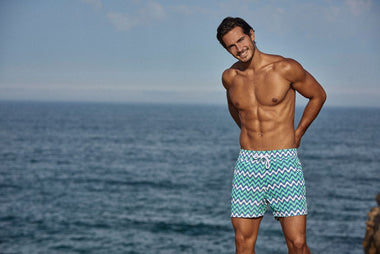 attractive man wearing mens designer board shorts 
