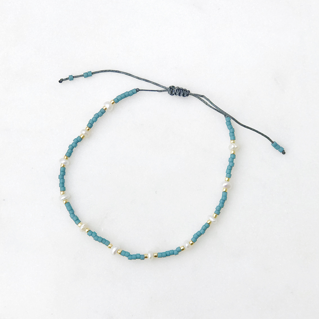Load image into Gallery viewer, Spaced Pearl Pull Tie Bracelet Dusty Blue - Bracelet
