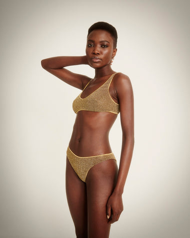 woman wearing a metallic gold bikini